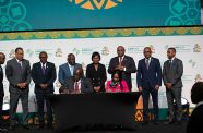 Reginald Saunders, Acting Permanent Secretary, Ministry for Grand Bahama (seated at left) and Kanayo Awani, Executive Vice President, Intra-African Trade and Export Development Bank, Afreximbank (seated at right) signing the agreement for the development of an Afro-Caribbean marketplace. Also in photo is Prime Minister of The Bahamas, Phillip Davis (third from left) and President of the Afreximbank, Benedict Oramah (third from right)