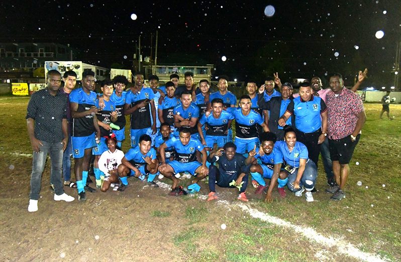 Mayor Gifford Marshall (left) and Regional Chairman, Kenneth Williams (right) pose with the victorious Region Seven team following their win and qualification for the semi-finals