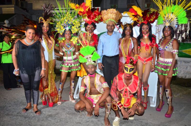 Dr. Frank Anthony (centre), dons a festive headwear by designer Carol Fraser, as he poses with models displaying 2015 Mashramani costumes. Far left in photo is veteran designer, Olympia Small-Sonoram