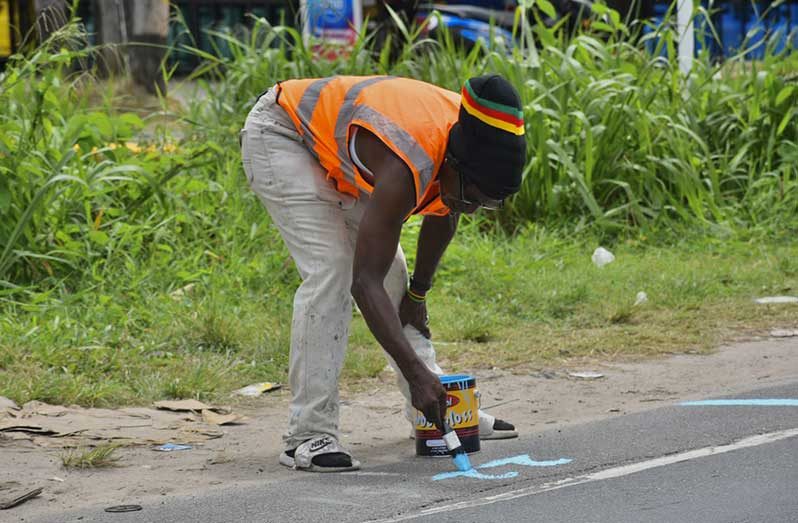 City workers mark designated vending spots along Vlissengen Road, as the Mayor and City Council ramps up early preparations for Mashramani 2026 (Sachin Persaud photo)