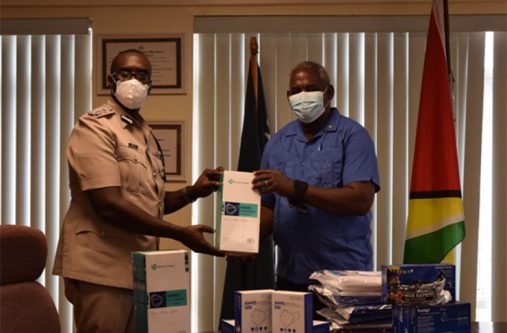 Minister of Home Affairs, Robeson Benn, handing over PPE to the Commissioner of Police (ag) Nigel Hoppie