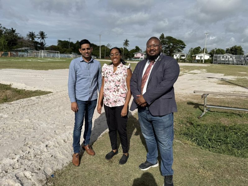 Fruta Conquerors FC President Martin Massiah (right) and Ravin Singh, Director of Projects and Policy at the Office of the First Lady (left), along with another representative at the ground