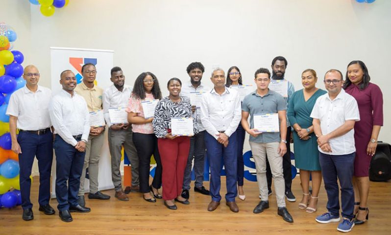 The trainees with their certificates flanked by Massy Guyana officials, after their successful training