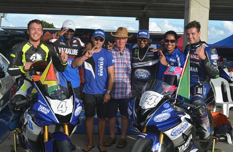 Matt Truelove (extreme right, sitting on the bike) and his brother Harry (extreme left) stand with the Team Mohamed’s Enterprise unit after standing tall in Barbados (Stephan Sookram photo)