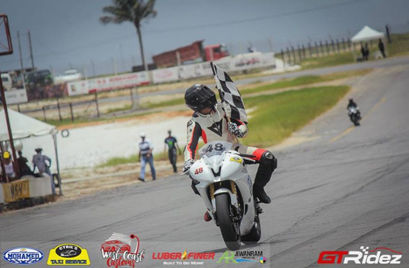 Matthew Vieira stares at his chequered flag after one of his victories last Sunday. (GTRidez photo)