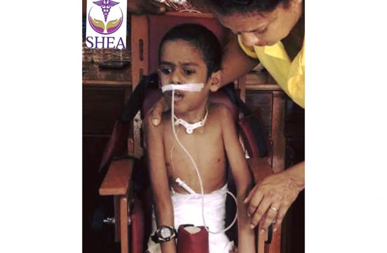 Young Matthew Zaman being assisted to sit up (SHEA foundation)