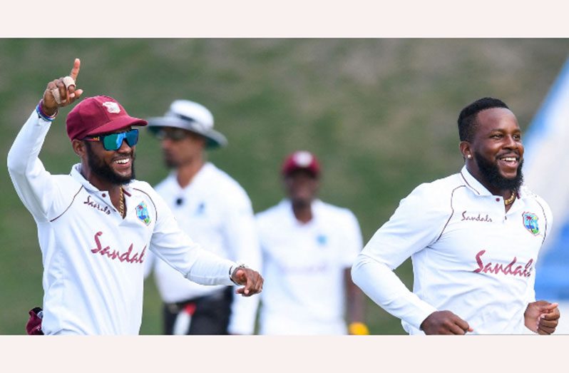 MAGIC ARM! Kyle Mayers celebrates one of his two wickets on Tuesday as he is joined by captain Kraigg Brathwaite.