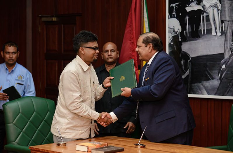 Acting President and Prime Minister Moses Nagamootoo presenting Mayor of Georgetown Pandit Ubraj Narine with his credentials