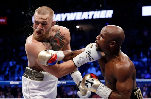 Conor McGregor (left) after catching a punch to the face during his fight with Floyd Mayweather.