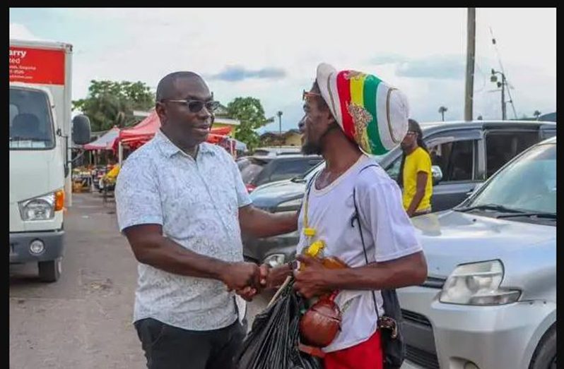 Minister McCoy engaging a resident during his walkabout