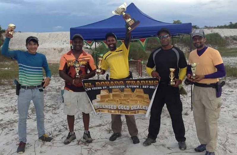 Ryan McKinnon (centre) raises the coveted Cup, flanked from left by John Phang, Rajiv Latchana and on the right by Michael Blake and Aleemul Ali.