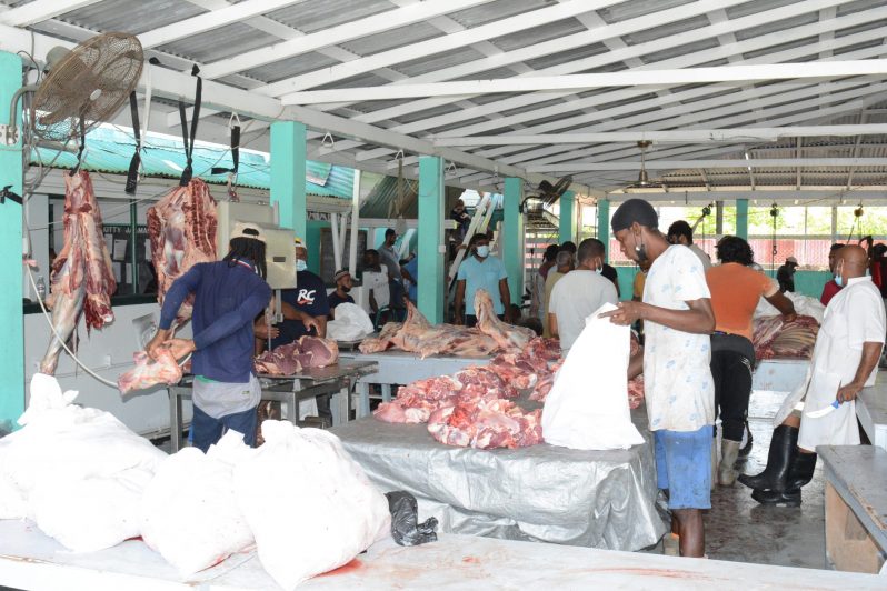 Meat being chopped with a machine and parcelled for distribution at the Kitty Masjid
