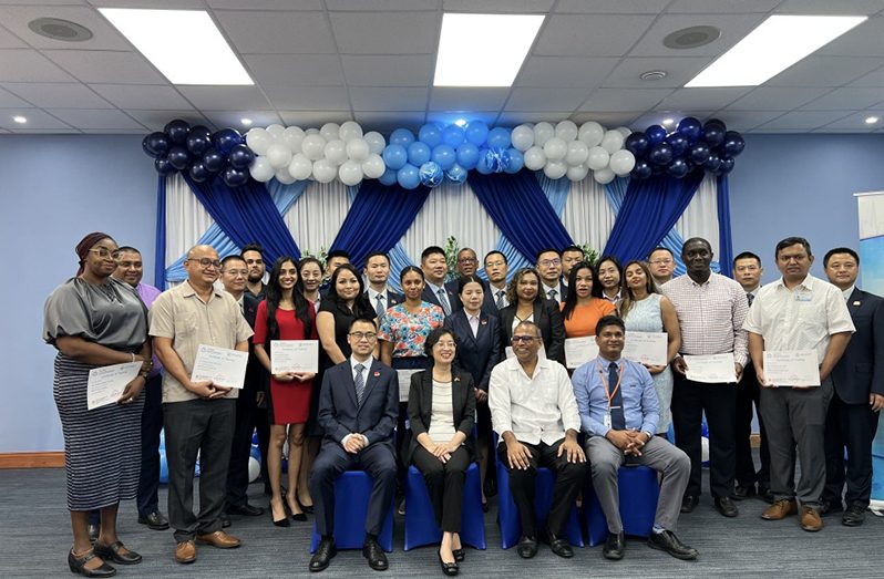 The specialist doctors who graduated from the Resident Training Programme, and officials of the Chinese Medical Brigade with Minister of Health Dr. Frank Anthony (seated second right) next to Ms. Guo Haiyan, Chinese Ambassador to Guyana (seated third right) along with other officials