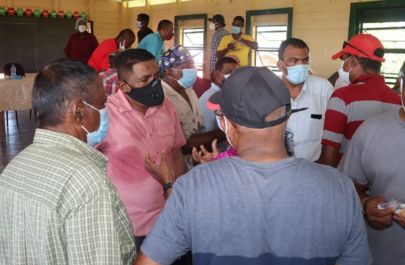 Minister Mustapha engaging a group of farmers from Wakenaam