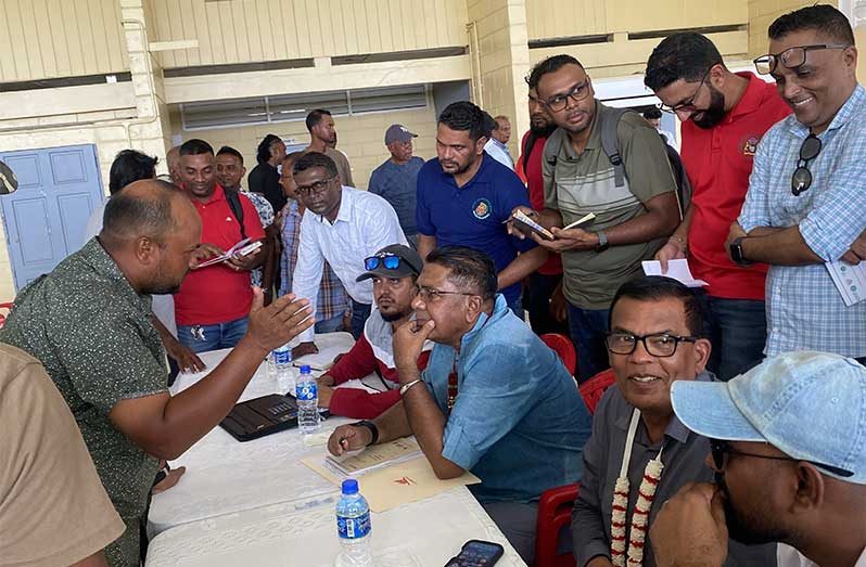 Minister of Agriculture, Zulfikar Mustapha, speaks with rice farmers at Anna Regina Secondary school