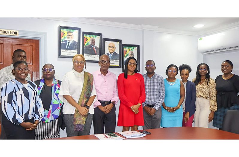 Fifth from left: Minister of Labour, Joseph Hamilton alongside Permanent Secretary Mrs. Mae Toussaint Jr. Thomas-Meerabux flanked by USAID representatives and officials at the Ministry of Labour