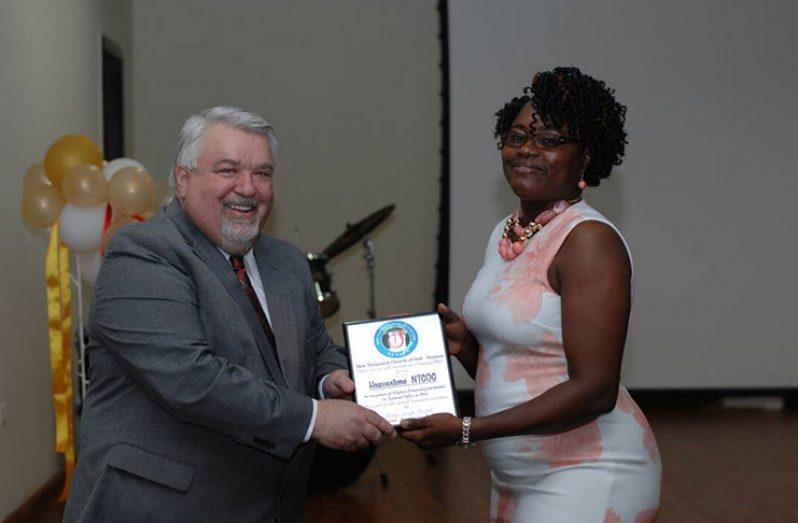 Dr. David Griffis presenting Harvestime NTCOG Mellissa Hinds with an award for the Highest Financial Contribution to the National Office