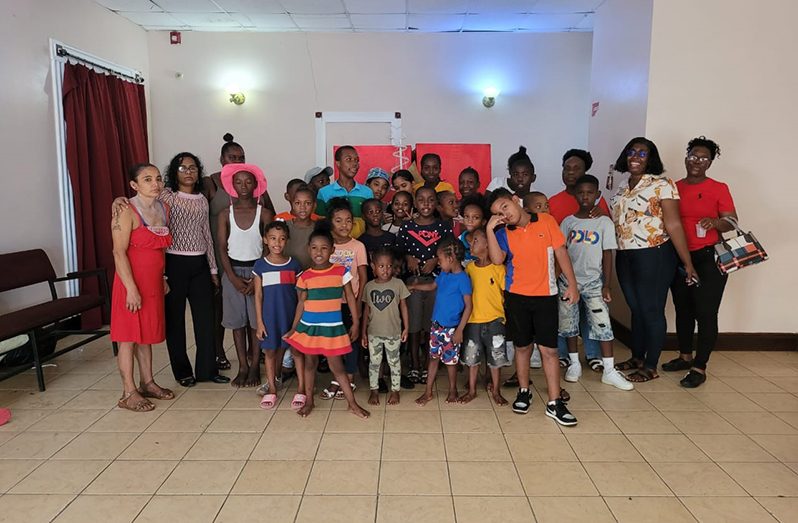 CODA members with some children following a gathering at Theatre Guild, Kingston during the festive season.