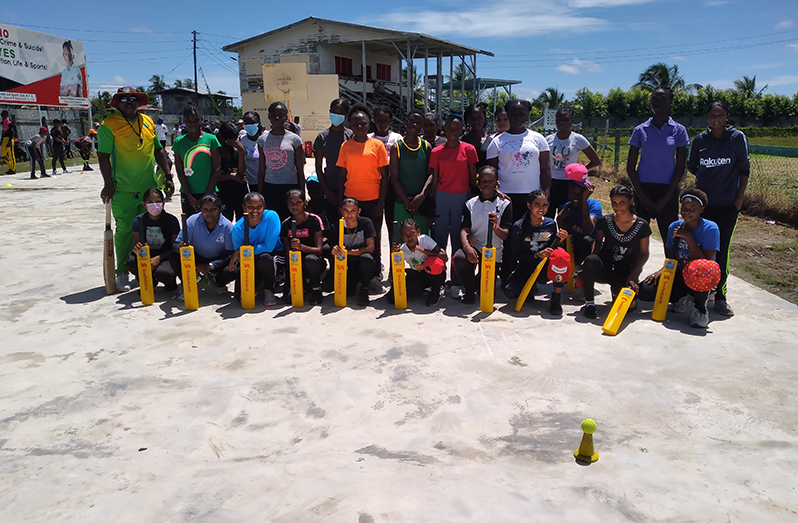 Members of the Bakewell/Busta Cricket Academy pose with their coaches and senior RHTYSC players