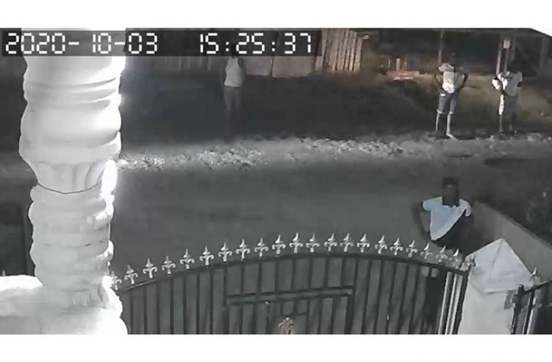 The men in front of the businessman’s house on Sunday  