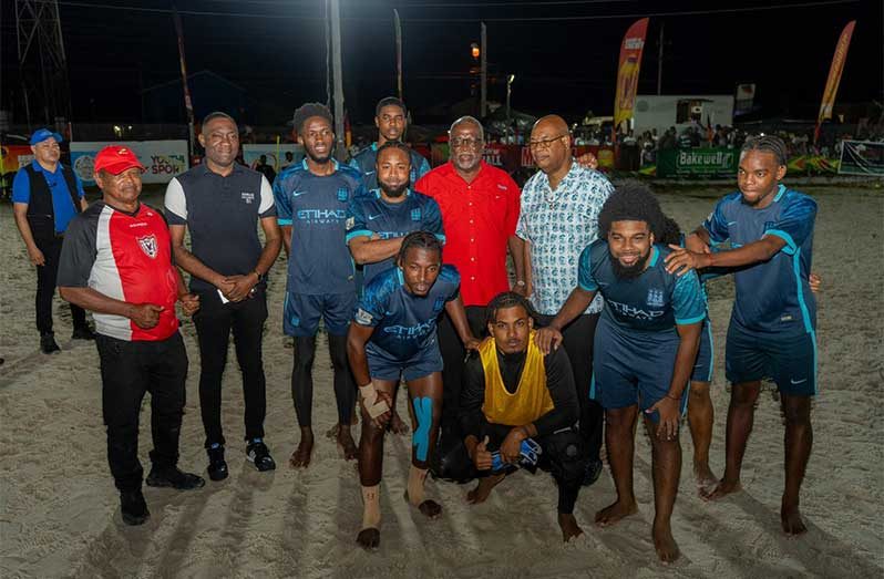 Prime Minister Mark Phillips, Minister Juan Edghill and other officials pose with 2025 'One Guyana' Kings of the Sand champions, LA Ballers
