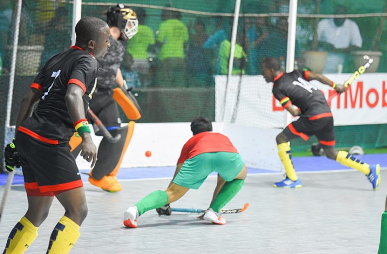 Robert France, (far right) scores one of his six goals in Guyana’s 12-0 rout of Mexico last evening at the Cliff Anderson Sports Hall. (Samuel Maughn photo)