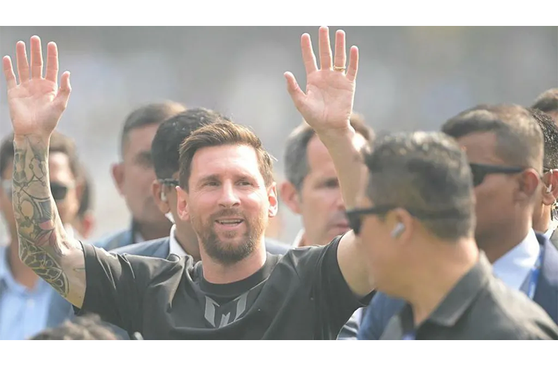 Lionel Messi waving to fans as he arrived