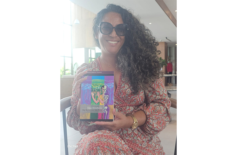 Michelle Singh and books that were on sale during the exhibition