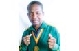Mike Parris wearing his Guyana uniform and displaying Guyana’s only Olympic medal