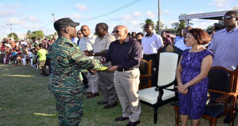 President Donald Ramotar receives a Golden Arrowhead from one of the parachutists during the Military Tattoo