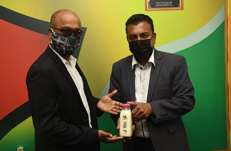 Managing Director of the Amaya Milk Company, Omkaar Sharma, and CEO of Go-Invest, Dr. Peter Ramsaroop, hold what is expected to be a revolutionary product and huge boost to the local dairy industry (Adrian Narine photo)