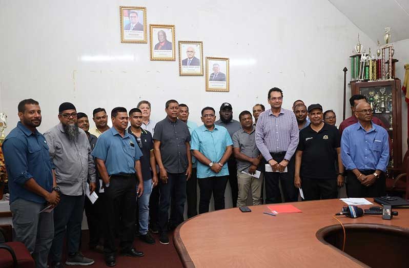 Minister of Agriculture, Zulfikar Mustapha (at centre) and the millers who received their payments on Wednesday (Ministry of Agriculture photos)