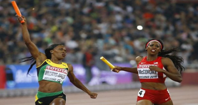 Novlene Williams-Mills of Jamaica (L) crosses the finish line beside Francena McCorory of the U.S. in the women's 4x400 metres relay final at the 15th IAAF Championships at the National Stadium in Beijing, China. (Reuters/Damir Sagolj)