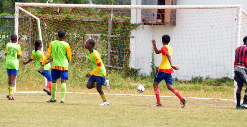 Part of the action  in Milo Under-20 schools football tournament yesterday. (Adrian Narine photo).
