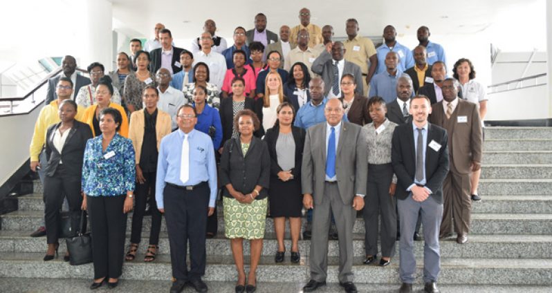 Minister of Natural Resources and the Environment Raphael Trotman stands with participants of the ACP-EU Development Minerals programme on Monday at the Arthur Chung Convention Centre, Lilendaal, East Coast Demerara