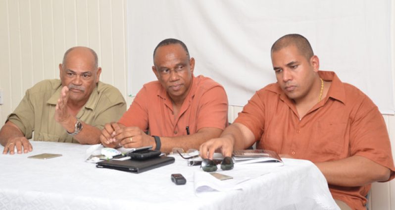 (L-R) GGDMA Executive Secretary Tony Shields addresses miners in the presence of GGMDA President Terrence Adams and Vice President Andron Alphonso