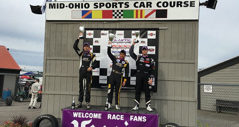 Calvin Ming (centre) stands on the podium with Phillippe Denes and Peter Portante after the 11th race of the F1600 series.