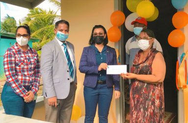Minister Susan Rodrigues hands over sponsorship cheque to BCB secretary, Angela Haniff