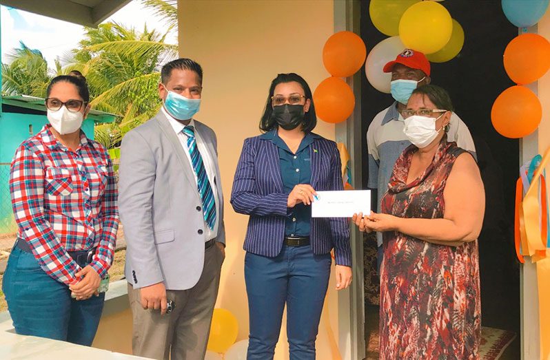 Minister Susan Rodrigues hands over sponsorship cheque to BCB secretary, Angela Haniff