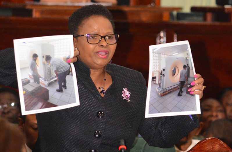 Here is the evidence!
Minister of Public Health Volda Lawrence holds two photographs which indicate that facilities at the New Amsterdam Hospital are in working order. She was at the time responding to claims made by Opposition MP, Dr Vishwa Mahadeo. (Adrian Narine photo)