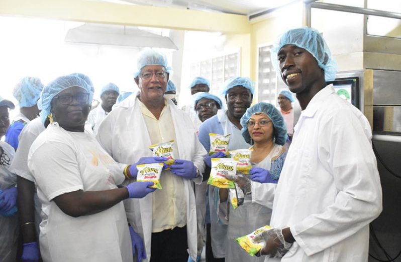 Minister Noel Holder, Mrs Ida Sealey Adams, and other heads of agencies, Board Members and GMC's Mechanical Engineer during a tour of the Parika Agro processing Facility