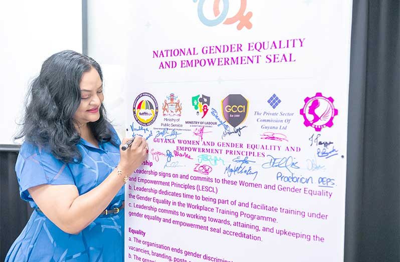 Minister of Human Services and Social Security, Dr Vindhya Persaud adds her signature to the Women and Gender Equality and Empowerment Principles.