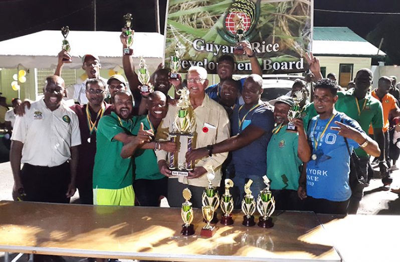 The winning GRDB cricket team with Minister of Agriculture Noel Holder.