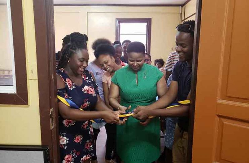 Minister of Public Health, Volda Lawrence, in the ribbon-cutting exercise to symbolise opening of the office.