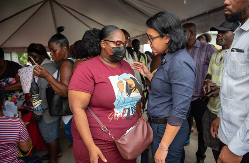 Minister within the Housing and Water Ministry, Susan Rodrigues, engaging one of the residents at Bare Root (DPI photo)