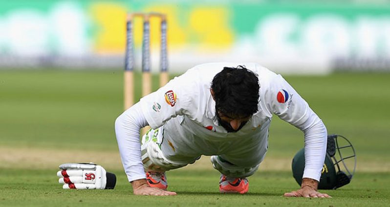 Misbah-ul-Haq marks his hundred with a set of push-ups.