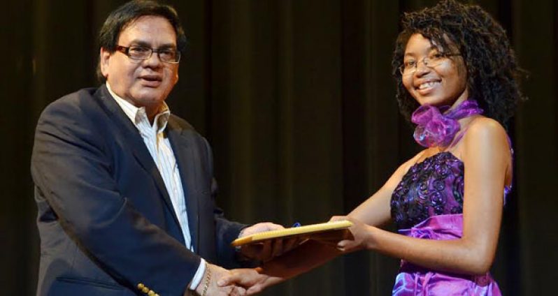 Dr Prem Misir presenting an award at the event hosted recently by Texila American University