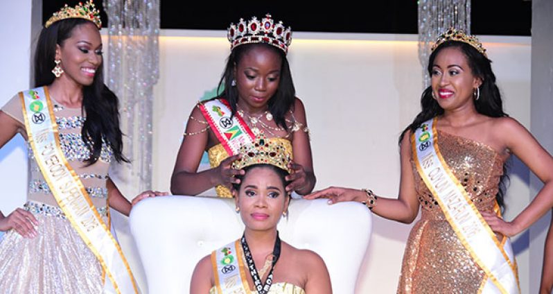 Nuriyyih Gerard is crowned by last year’s queen, Lisa Punch. At left is third place winner Najuma Nelson, and at right is second place winner Treasure James