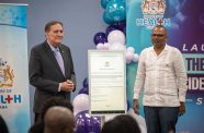 Minister of Health, Dr Frank Anthony (right) and PAHO Director, Dr Jarbas Barbosa (left), are photographed alongside the electronic surveillance form as part of the newly launched system (Delano Williams Photo)