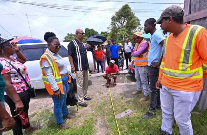 Minister of Public Works Bishop Juan Edghill with contractor, NDC representatives and vendors during the development of a relocation area (DPI photo)